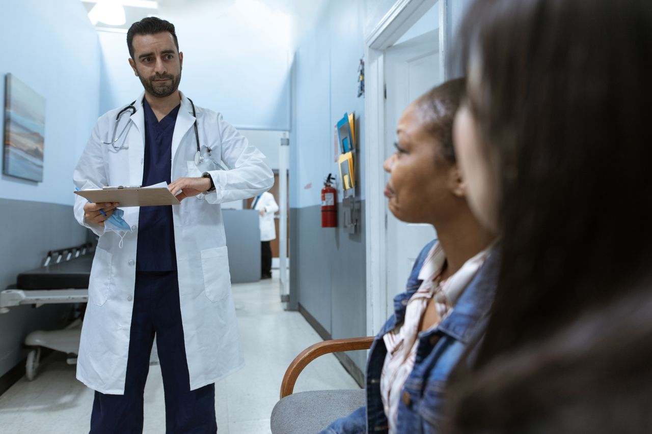Offerings Doctor in a healthcare setting consulting patients, promoting health and wellness.