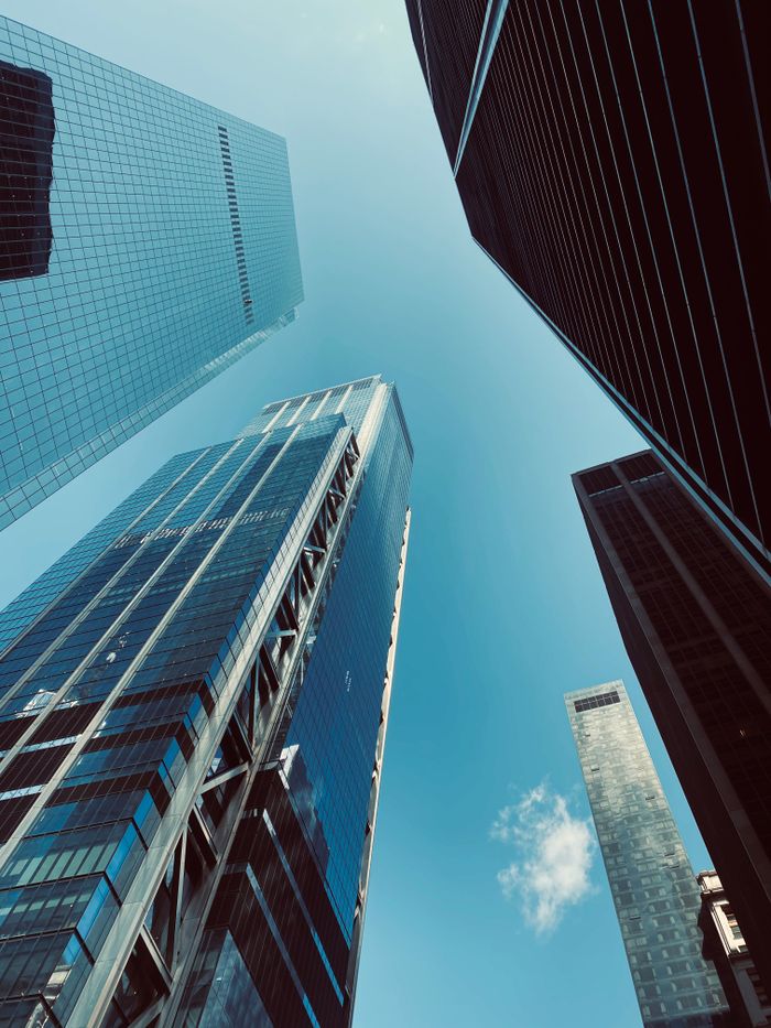 Crafting Captivating Headlines: Your awesome post title goes here A stunning low-angle shot of skyscrapers reaching into a clear blue sky, capturing urban architectural beauty.